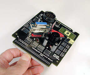 Two circular plastic connectors and a DB15 are mounted on this board.