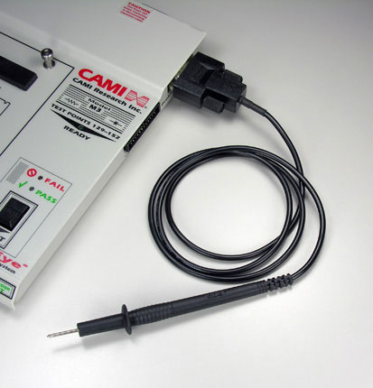 Image of black test probe attached to 24 pin header bank of a low voltage continuity and resistance tester.